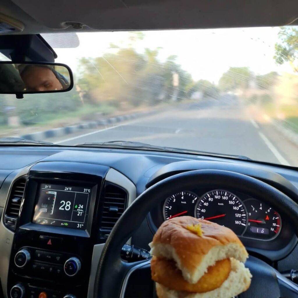 Matte-black hybrid at 3 AM Mumbai pump, cat licks diesel, 1,042 km glows.