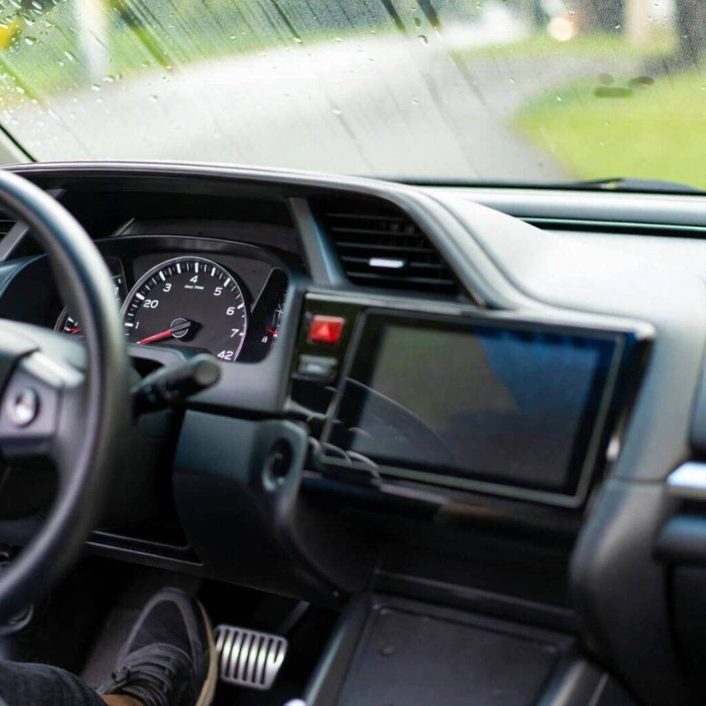 Sneakers on brake in 2016 Civic, 42 mph, rain-streaked windshield.