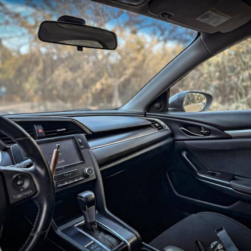 POV inside worn 2018 Civic: cracked dash, vape pen, 68k miles owned free in golden light.