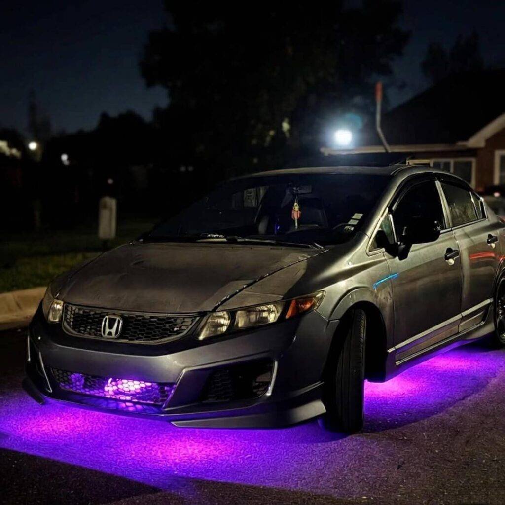 Purple underglow Honda Civic at night, Ring camera red light glaring judgmentally.
