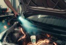 Hybrid Cars Maintenance: What You Need to Know Prius hood open, glowing orange coolant lines tangle around forgotten Starbucks cup under flashlight beam.