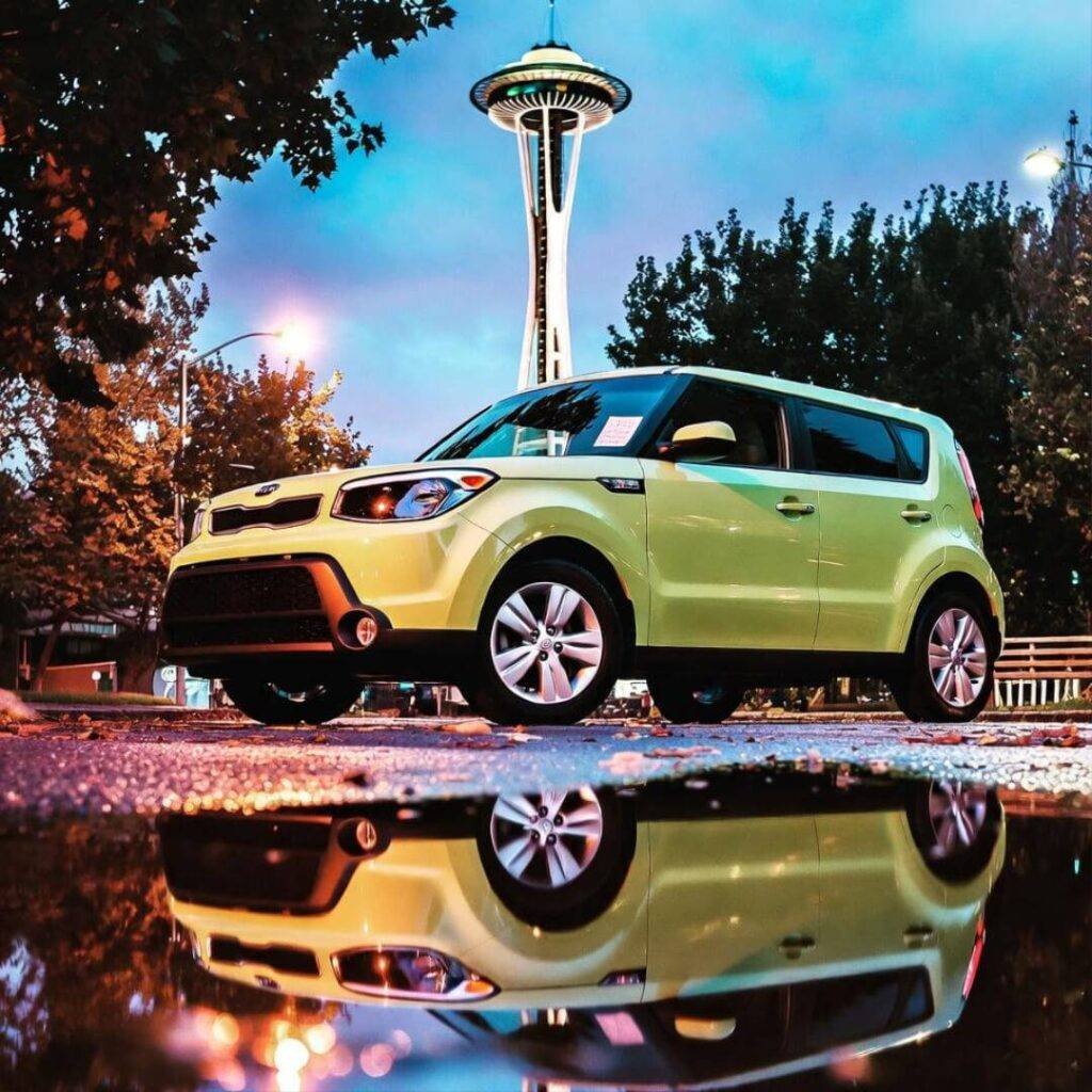 Lime green Kia Soul under Space Needle, puddle reflection, "DON'T CRASH" note.
