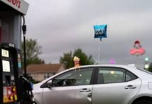 Fuel-Efficient Sedans That Won’t Break the Bank Dented Corolla with melting Frosty, deflated balloon, flip-flop under tire at E85 pump.