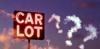 Buying a Used Car? Check These 10 Reliability Ratings First Dusty 2009 Honda Civic under flickering CAR LOT neon, burger on hood, smoky question marks at dusk.