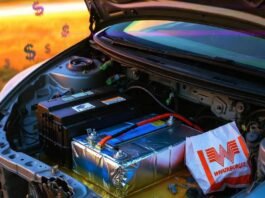 Lead-Acid vs. Lithium Car Batteries: What’s Right for You? Spilled acid dissolves "I Voted" sticker in chaotic Civic battery bay with lithium pack and Whataburger bag.