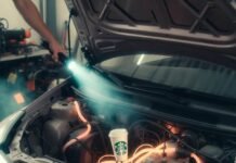 Hybrid Cars Maintenance: What You Need to Know Prius hood open, glowing orange coolant lines tangle around forgotten Starbucks cup under flashlight beam.