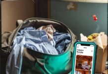 Best Short-Term Rentals for Road Trips & Business Travel Duffel bag spills shirts beside cooling burrito and cabin rental on cracked phone.