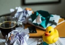 Avoid These Pitfalls When Renting Long-Term Messy Seattle coffee table with crumpled leases, spilled coffee, key, and rubber duck.