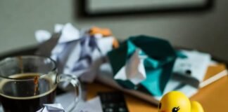 Avoid These Pitfalls When Renting Long-Term Messy Seattle coffee table with crumpled leases, spilled coffee, key, and rubber duck.